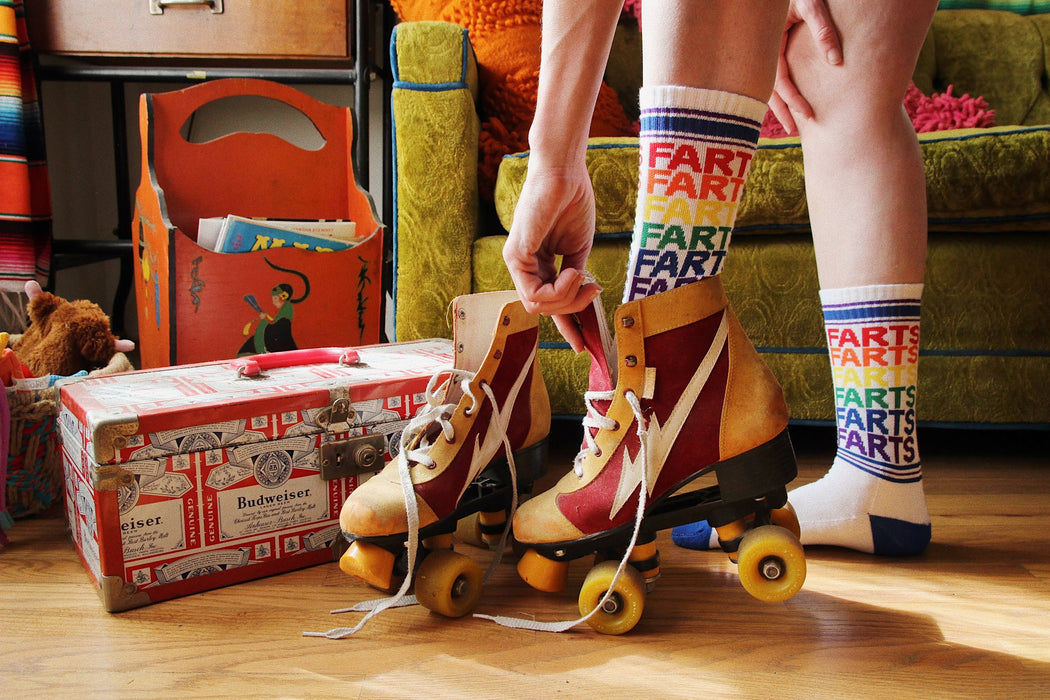 Lifestyle shot of model wearing the 'Farts' socks with roller skates.
