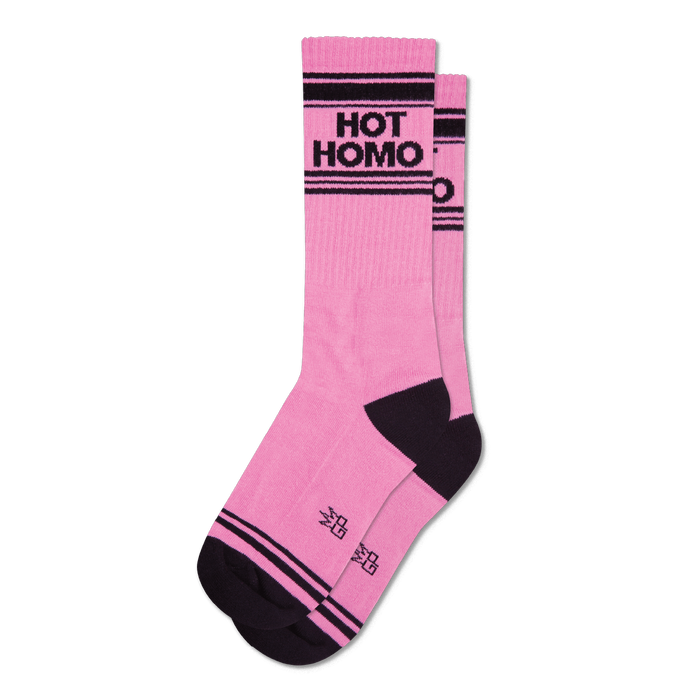 A pair of pink crew socks with black stripes and 'Hot Homo' in black lettering. The socks have a dark charcoal heel and toe. }}