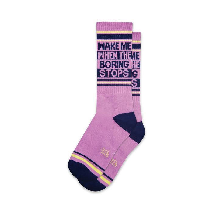 Pair of lavender crew socks with navy and yellow accents.  Text reads: 'Wake Me When the Boring Stops'.