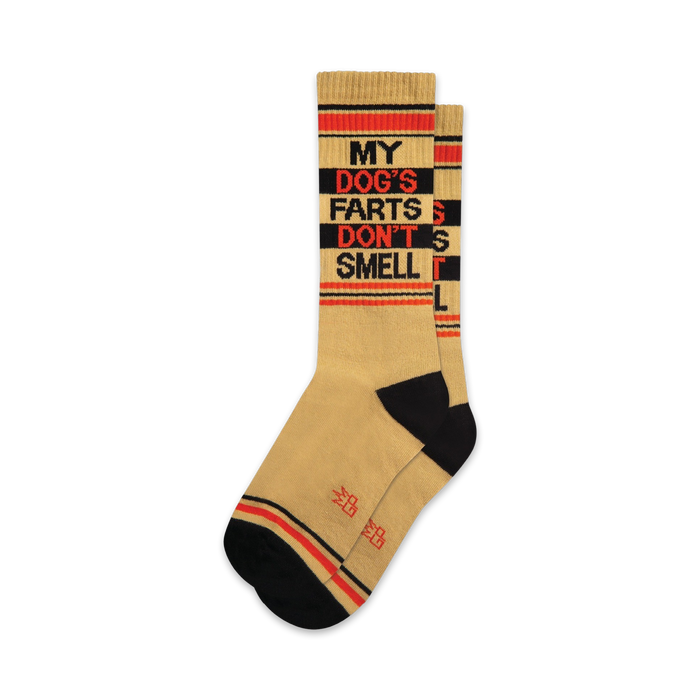 A pair of tan crew socks with black and orange stripes and the text 'MY DOG'S FARTS DON'T SMELL' in black.