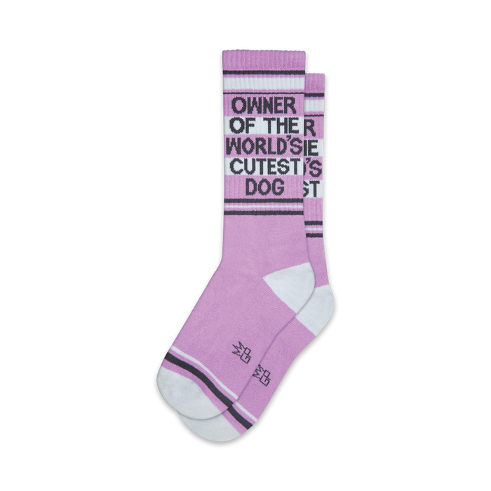 Pair of lavender crew socks with a dark gray 'Owner of the World's Cutest Dog' graphic and white/gray stripes near the cuffs. }}