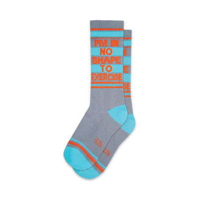 Pair of crew socks in grey, teal, and orange. The socks feature the text 'I'm in no shape to exercise' repeated vertically.