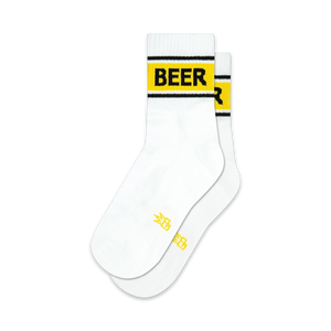 white quarter length socks with yellow lettering spelling out 