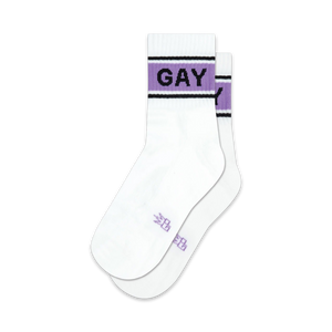 Pair of white crew socks with a lavender and black band reading 'GAY'.