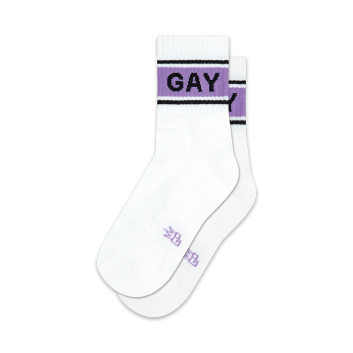 Pair of white crew socks with a lavender and black band reading 'GAY'.