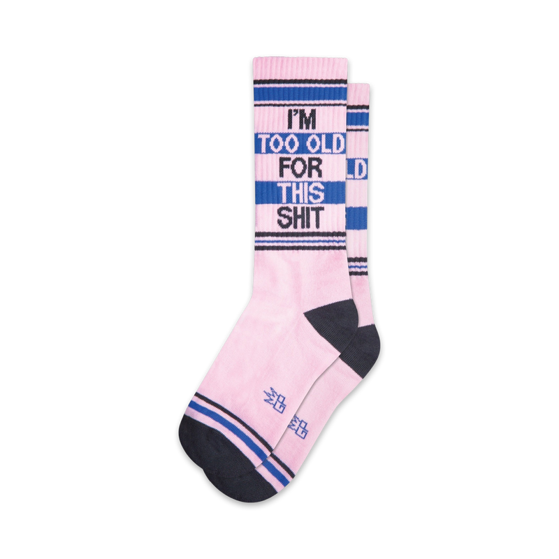 Pair of pink crew socks with navy blue and black stripes. The socks feature the text 'I'm Too Old For This Shit' in a bold font.
