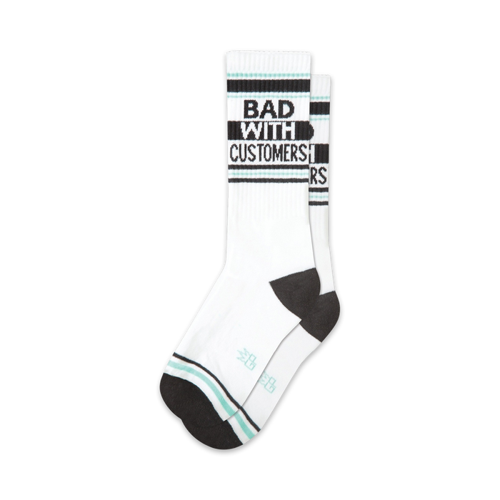 Pair of white crew socks with black and teal stripes and the text 'BAD WITH CUSTOMERS' in black. }}