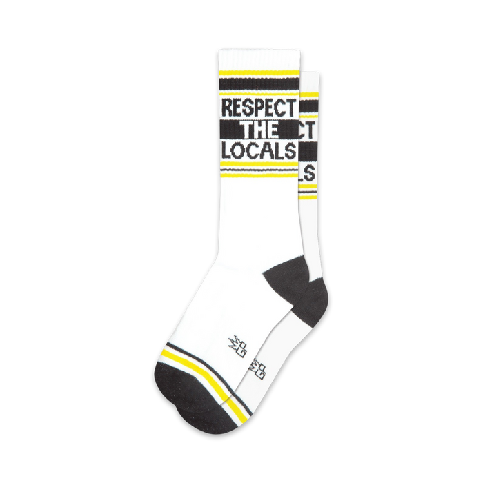 Pair of white crew socks with black and yellow stripes and the text 'Respect The Locals'.