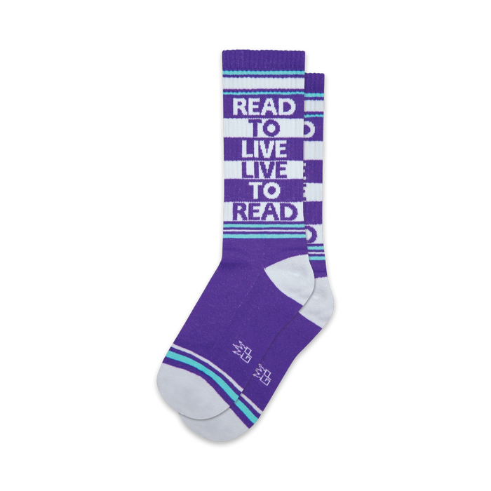 A pair of purple crew socks with white and teal stripes. The socks feature the text 'Read To Live Live To Read' in white. }}