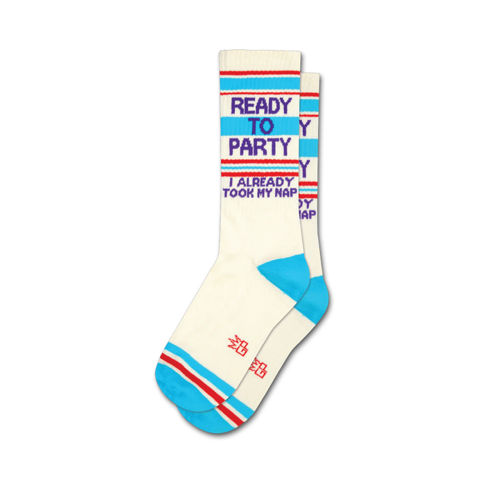 Pair of cream crew socks with blue, red, and purple stripes and the text 'Ready to Party, I Already Took My Nap'. }}