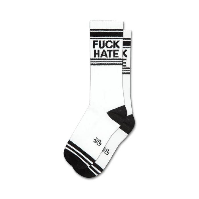 Pair of white crew socks with black stripes at the top and bottom. 'FUCK HATE' is printed in black. }}
