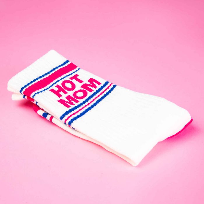 Close-up detail shot of a folded 'Hot Mom' sock, showcasing the fabric and design elements on a pink background.