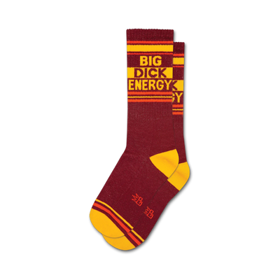 Pair of maroon crew socks with yellow and orange stripes.  The socks feature the text 'BIG DICK ENERGY' in a retro style.