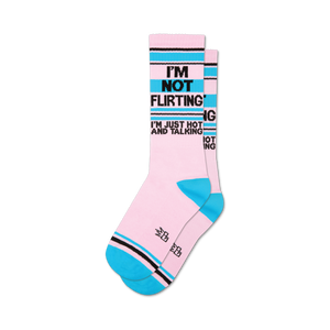 Pair of crew socks in pink, teal, and black.  The socks feature the text: 'I'm Not Flirting, I'm Just Hot and Talking'.