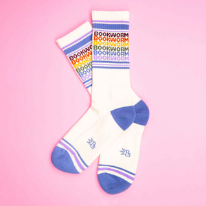 Flat lay product shot of Bookworm socks on a pink background.