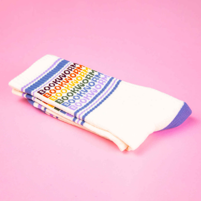Folded pair of Bookworm socks on a pink background.