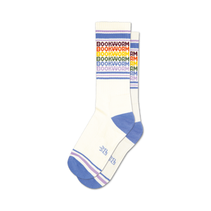 Pair of white crew socks with rainbow-colored 'Bookworm' text and purple and blue stripes at the cuff.