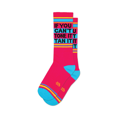 A pair of pink crew socks with teal cuffs and yellow stripes.  Black text reads 'If You Can't Tone It, Tan It'.