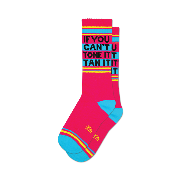 A pair of pink crew socks with teal cuffs and yellow stripes. Black text reads 'If You Can't Tone It, Tan It'. }}