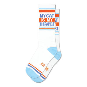 Pair of white crew socks with orange and light blue stripes and the text 'My Cat Is My Therapist'.