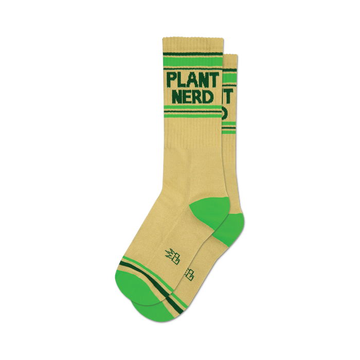 socks that are plant nerd themed. they are mostly tan with the words 'plant nerd' in green letters on the leg of the sock. the heel and toe are bright green. the top of the sock is banded in two green stripes. the plant nerd logo, a small green square with the letters 'pn' in a darker green, is on the outside of the leg of the sock above the heel. }}