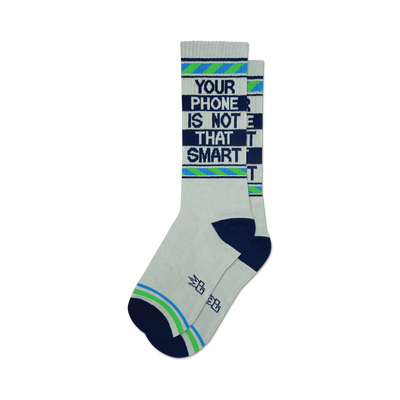 A pair of white crew socks with navy blue and light green stripes and the text 'Your Phone Is Not That Smart' in dark blue.