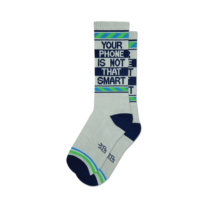A pair of white crew socks with navy blue and light green stripes and the text 'Your Phone Is Not That Smart' in dark blue. }}