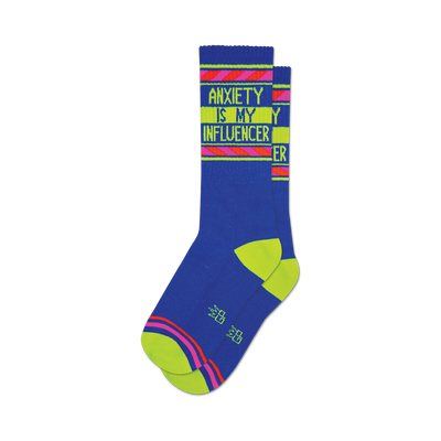 Pair of blue crew socks with neon yellow and pink stripes and the text 'Anxiety Is My Influencer' on the leg.