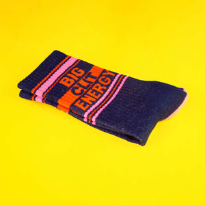 Close-up shot of a single 'Big City Energy' sock folded on a yellow background, highlighting the details of the design.
