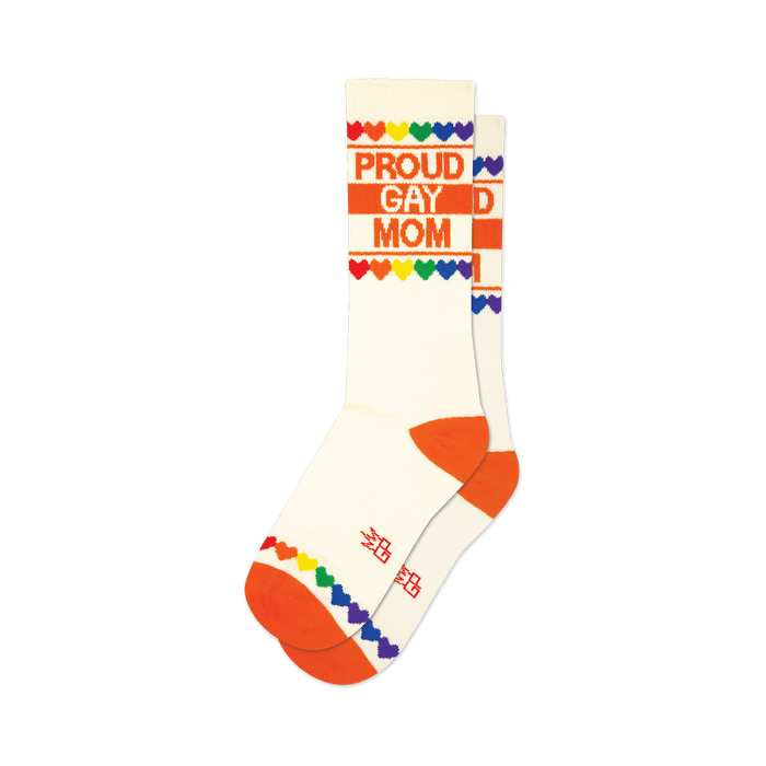 Cream crew socks with orange cuffs and toes.  'Proud Gay Mom' is printed in orange, accented by a rainbow heart border.