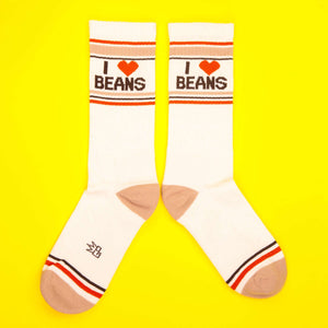 Flatlay of 'I Heart Beans' socks on a yellow background.