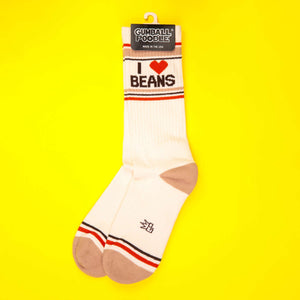 'I Heart Beans' socks on yellow background, shown with packaging.