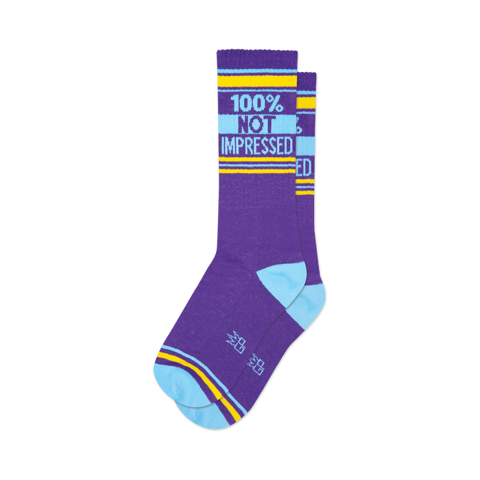 Pair of purple crew socks with light blue and yellow stripes and the text '100% NOT IMPRESSED'.
