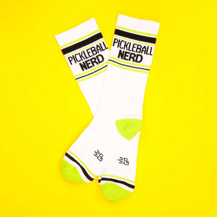 Two Pickleball Nerd socks on a yellow background.