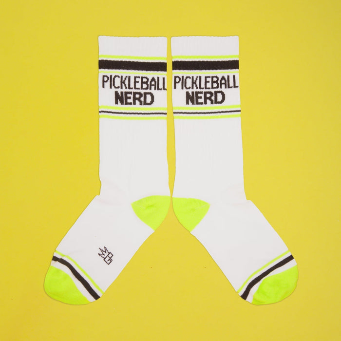 Pickleball Nerd socks on a yellow background, still on packaging.