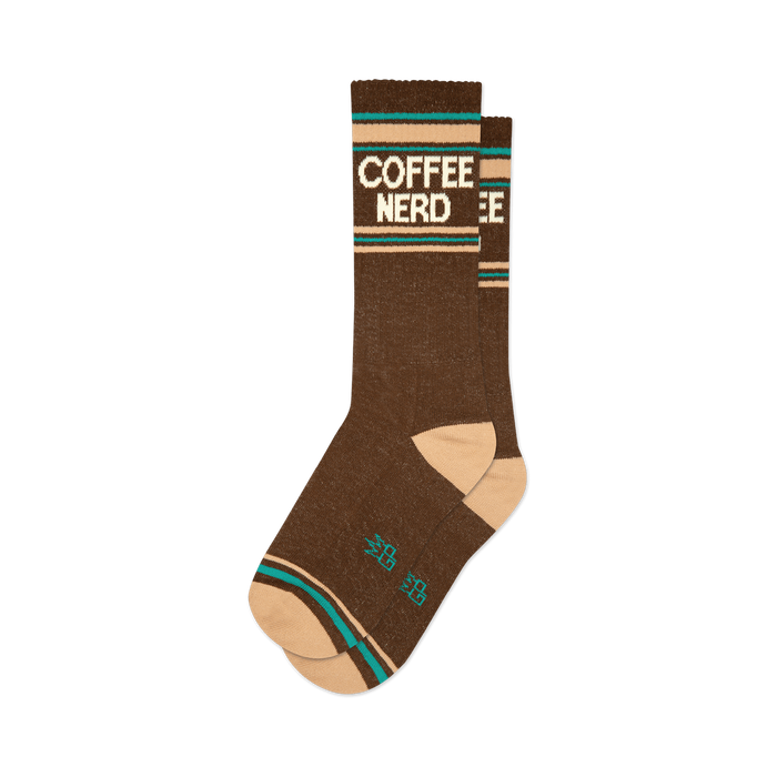 Pair of brown crew socks with a retro-style 'COFFEE NERD' graphic in cream and teal.  Features a peach-colored cuff.