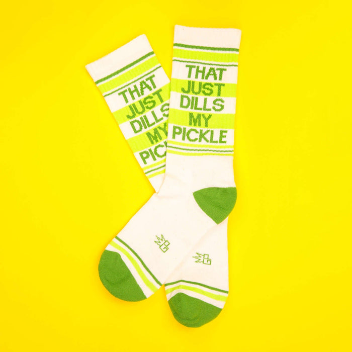 Flat lay of 'That Just Dills My Pickle' socks on a yellow background.