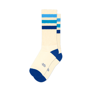 Pair of off-white crew socks with horizontal blue stripes in varying shades. Blue accents at the heel and toe. Retro style.