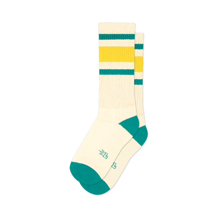 Pair of cream crew socks with green and gold stripes and teal cuffs.
