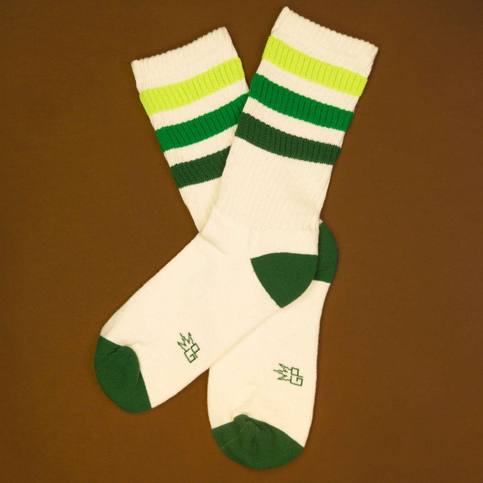 Flat lay product shot of Greg socks on a brown background, highlighting the color and design.