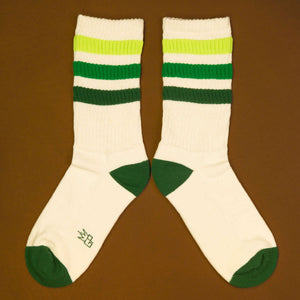 Flat lay product shot of Greg socks on a brown background, showing the socks laid out.