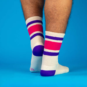 Lifestyle shot:  Person wearing Jan socks, showcasing the socks on legs against a blue background.