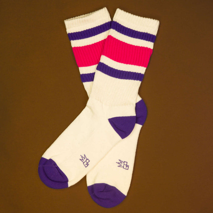 Flat lay: Pair of Jan socks on brown background, showing the full design.