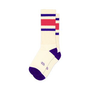 Pair of cream crew socks with purple and hot pink stripes. Purple cuffs. Small logo on the sole.