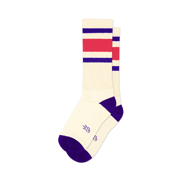 Pair of cream crew socks with purple and hot pink stripes. Purple cuffs. Small logo on the sole.