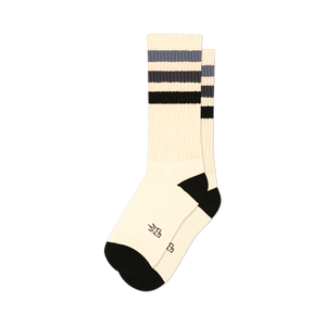 Pair of off-white crew socks with black and grey horizontal stripes. Black cuffs and subtle embroidered logo.