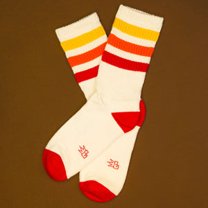 Flat lay: Pair of Tiger socks on brown background.