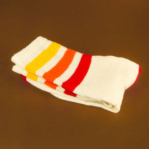 Folded Tiger socks on brown background.