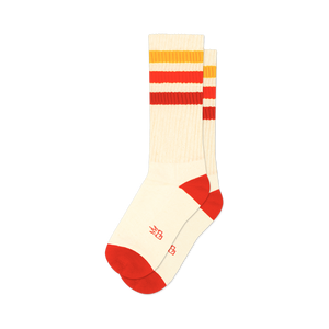 Pair of cream crew socks with red, orange, and yellow horizontal stripes. Red accents at the heel and toe. Small logo on the bottom.
