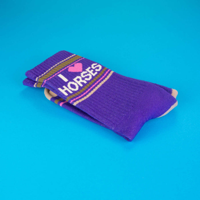 Close-up of folded purple 'I Heart Horses' socks highlighting the design details.